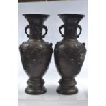 Pair of Japanese bronze Meiji period twin handled vases with bird and blossom decoration, height 48c