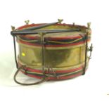 Brass and wood marching/side drum with original drumsticks. Maker mark to brass, Butler Haymarket Lo