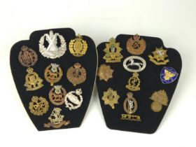 Collection of twenty one military badges including Cameron Highlanders of Canada and various British