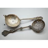 Two silver tea strainers, William Hutton & Sons Ltd London 1895 and HH Sheffield 1945 respectively,
