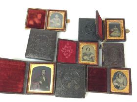 Nine daguerreotype portraits in decorative folding frames.
