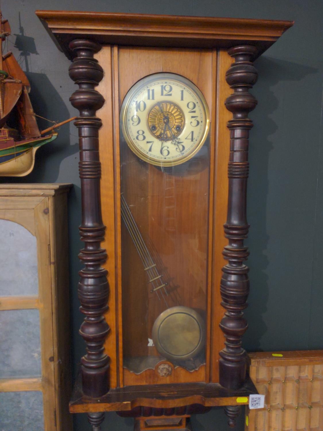 19th/20th century German style wall clock. Ceramic face with brass surround and brass pendulum with 