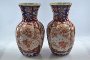 Pair of Japanese Imari vases decorated with figures and foliage, height 25cm, dia. approx. 14cm
