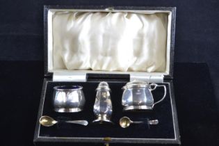 Three piece silver cruet set, Barker Brothers Silver Ltd, Birmingham 1933-34, with salt and mustard