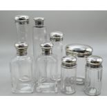 Set of six silver lidded vanity bottles, maker's mark rubbed, London 1911, together with a similar b