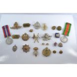 WWII Defence medal and 1939-1945 war medal together with assorted cap badges, buttons and fabric bad