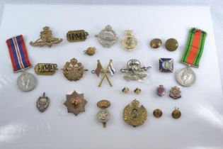 WWII Defence medal and 1939-1945 war medal together with assorted cap badges, buttons and fabric bad