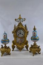 Gilt metal and hand painted porcelain three piece mantle clock garniture, late C19th/early C20th, de