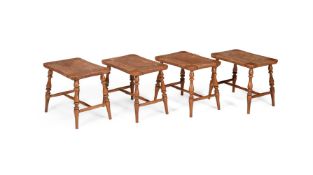 A SET OF FOUR BEECH AND RUSH STOOLS OR LUGGAGE STANDS