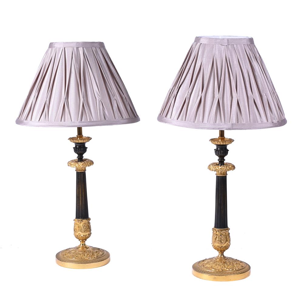 A PAIR OF BRONZE AND PARCEL GILT TABLE LAMPS