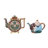 A MINTON MAJOLICA TEAPOT AND COVER MODELLED AS A CHINESE-FIGURE