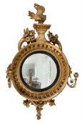 A REGENCY GILTWOOD AND COMPOSITION CONVEX WALL MIRROR