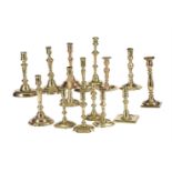 A COLLECTION OF FIFTEEN VARIOUS BRASS CANDLESTICKS