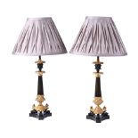 A PAIR OF BRONZE AND PARCEL GILT TABLE LAMPS