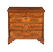 A WALNUT CHEST OF DRAWERS