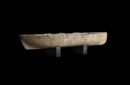 AN UNUSUAL CARVED MARBLE MODEL OF A BOAT, POSSIBLY A WHALEBOAT