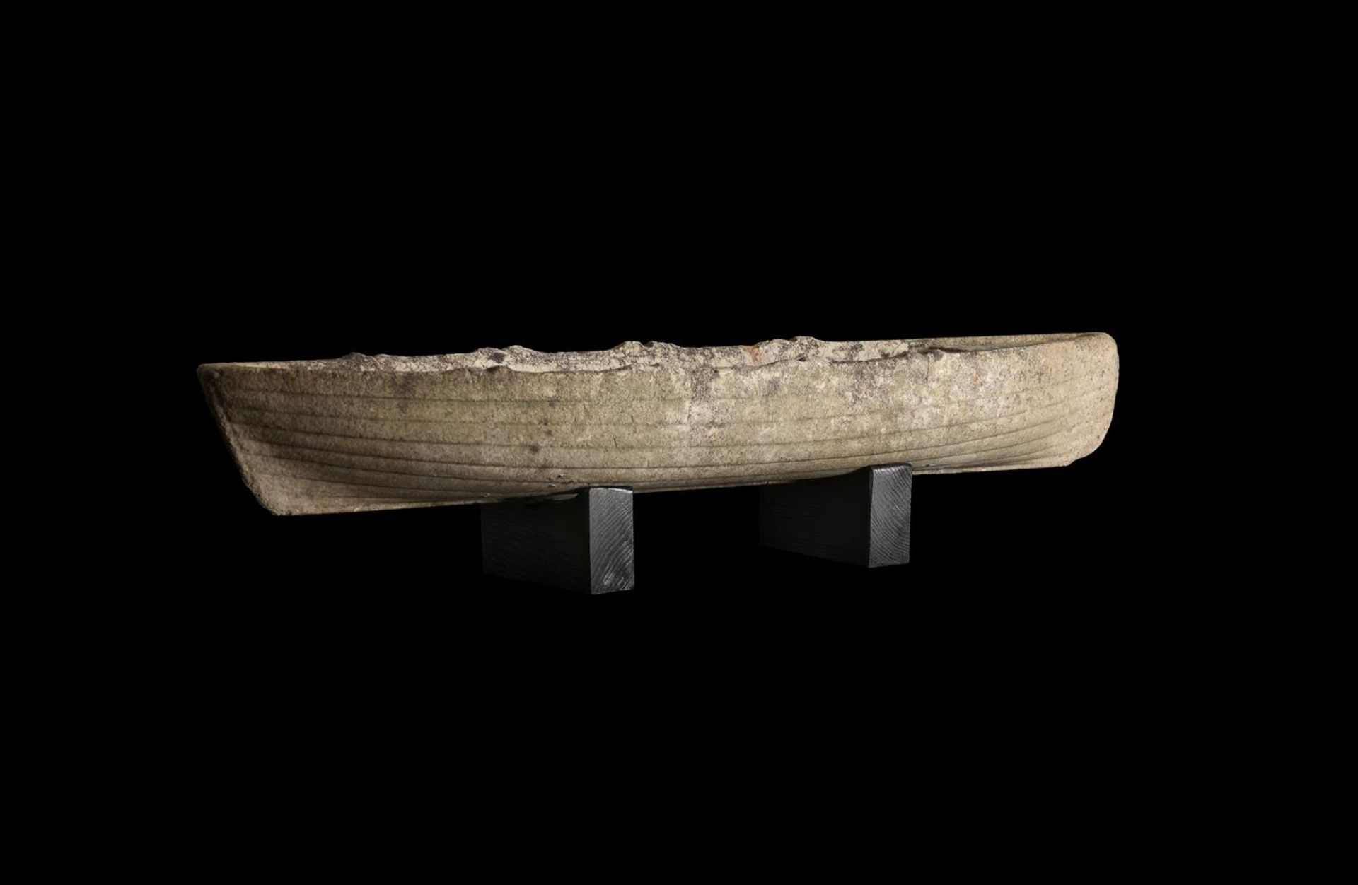 AN UNUSUAL CARVED MARBLE MODEL OF A BOAT, POSSIBLY A WHALEBOAT