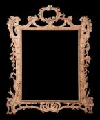 A CARVED PINE OVERMANTEL OR WALL MIRROR FRAME