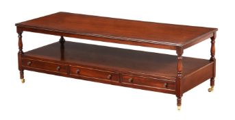 A MAHOGANY LOW OCCASIONAL TABLE IN REGENCY STYLE