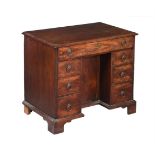 A GEORGE III MAHOGANY KNEEHOLE DESK