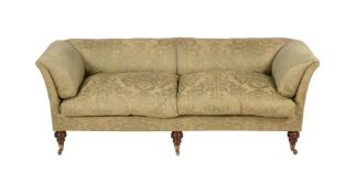 A GREEN UPHOLSTERED ROLL-BACK SOFA IN VICTORIAN STYLE