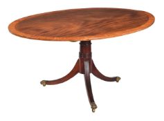 A REGENCY MAHOGANY AND SATINWOOD CROSSBANDED OVAL CENTRE TABLE