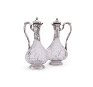A PAIR OF FRENCH SILVER MOUNTED CUT GLASS CLARET JUGS