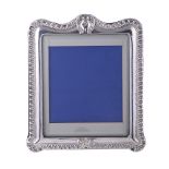 A VICTORIAN SILVER MOUNTED SHAPED RECTANGULAR PHOTO FRAME