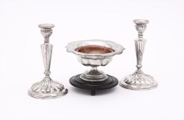 A PAIR OF CONTINENTAL SILVER COLOURED CANDLESTICKS
