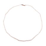 A GRADUATED SEED PEARL AND PEARL NECKLACE