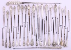 A COLLECTION OF SILVER HANDLED BOOT AND BUTTON HOOKS