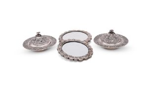 A PAIR OF EGYPTIAN SILVER COLOURED SHAPED CIRCULAR DISHES AND COVERS