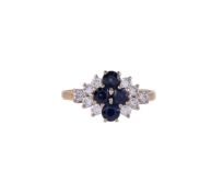 AN 18 CARAT GOLD, SAPPHIRE AND DIAMOND CLUSTER RING, LONDON 1985