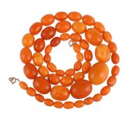 A GRADUATED AMBER NECKLACE