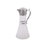 A LATE VICTORIAN SILVER MOUNTED CUT GLASS CLARET JUG