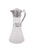 A LATE VICTORIAN SILVER MOUNTED CUT GLASS CLARET JUG