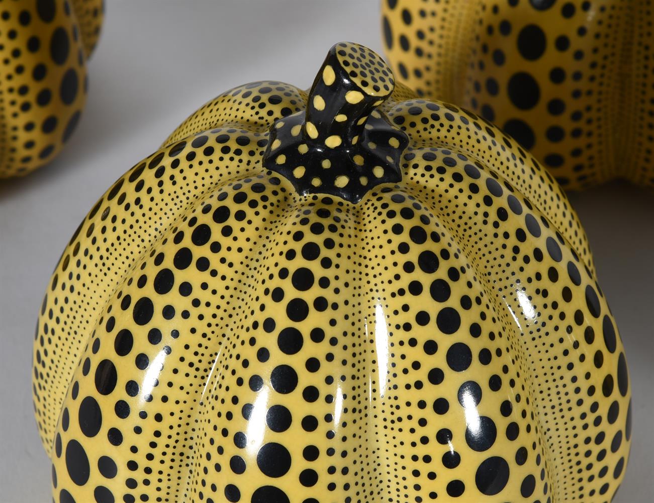 A SET OF FOUR YELLOW GLASS AND BLACK ENAMELLED MODELS OF PUMPKINS AFTER YAYOKI KUSAMA - Image 2 of 2