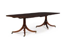 A MAHOGANY TWIN PEDESTAL EXTENDING DINING TABLE, IN GEORGE III STYLE