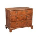 A WALNUT CHEST OF DRAWERS