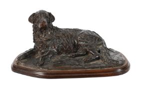 A PATINATED BRONZE MODEL OF A RECUMBENT HOUND