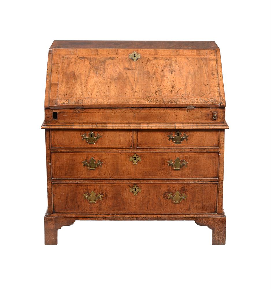 A GEORGE I WALNUT AND FEATHER BANDED BUREAU