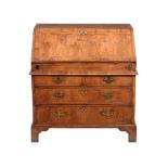 A GEORGE I WALNUT AND FEATHER BANDED BUREAU