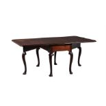 A GEORGE II MAHOGANY DROP LEAF TABLE