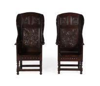 A PAIR OF VICTORIAN CARVED OAK WING ARMCHAIRS IN 17TH CENTURY STYLE