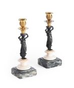 A PAIR OF NORTH EUROPEAN BRONZE, WHITE, AND VARIAGATED MARBLE CANDLESTICKS