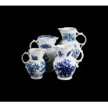 THREE VARIOUS WORCESTER AND CAUGHLEY BLUE AND WHITE PRINTED CABBAGE LEAF MOULDED MASK JUGS