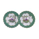 A PAIR OF WORCESTER APPLE-GREEN GROUND PLATES PAINTED WITH EXOTIC OR 'FANCY BIRDS'