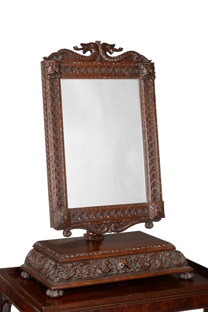 A VICTORIAN CARVED OAK DRESSING MIRROR