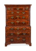 A GEORGE II FIGURED WALNUT AND FEATHER BANDED CHEST ON CHEST