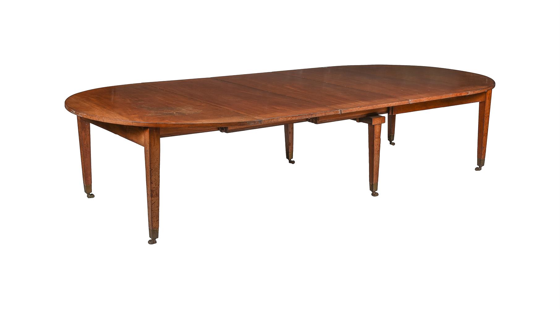 A GEORGE III MAHOGANY EXTENDING DINING TABLE